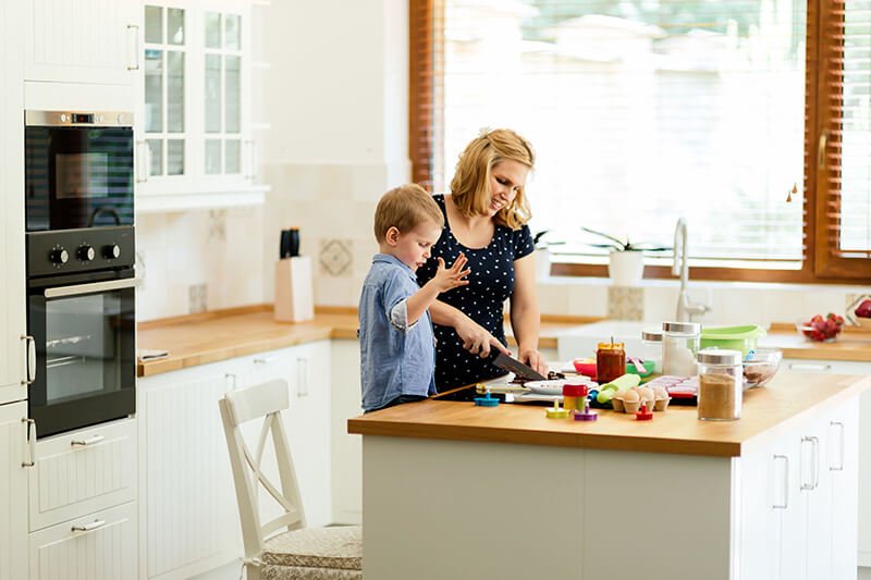woman and child cooking in a New Kitchen - LSK Building Westbury, Warminster and Trowbridge